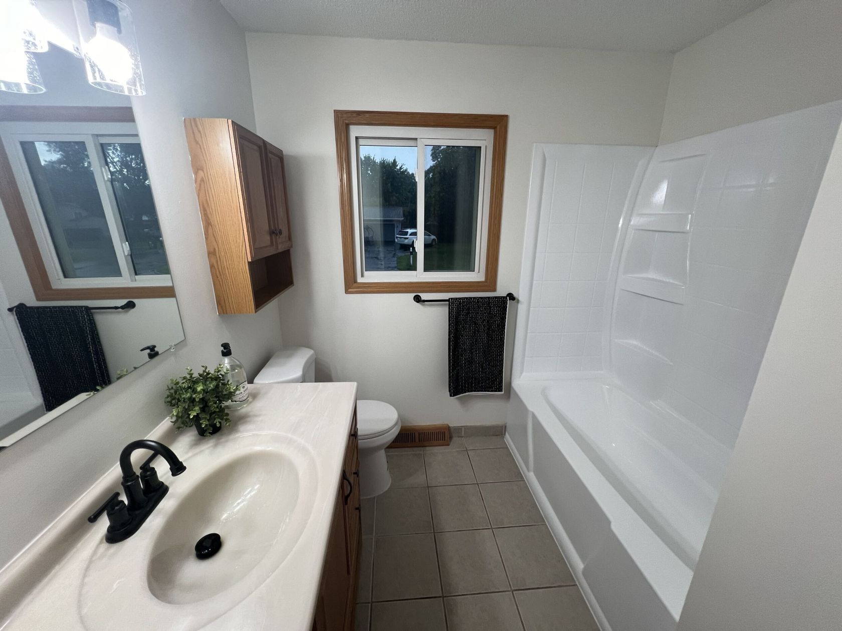 Updated full bath with matte black fixtures at Emerson
