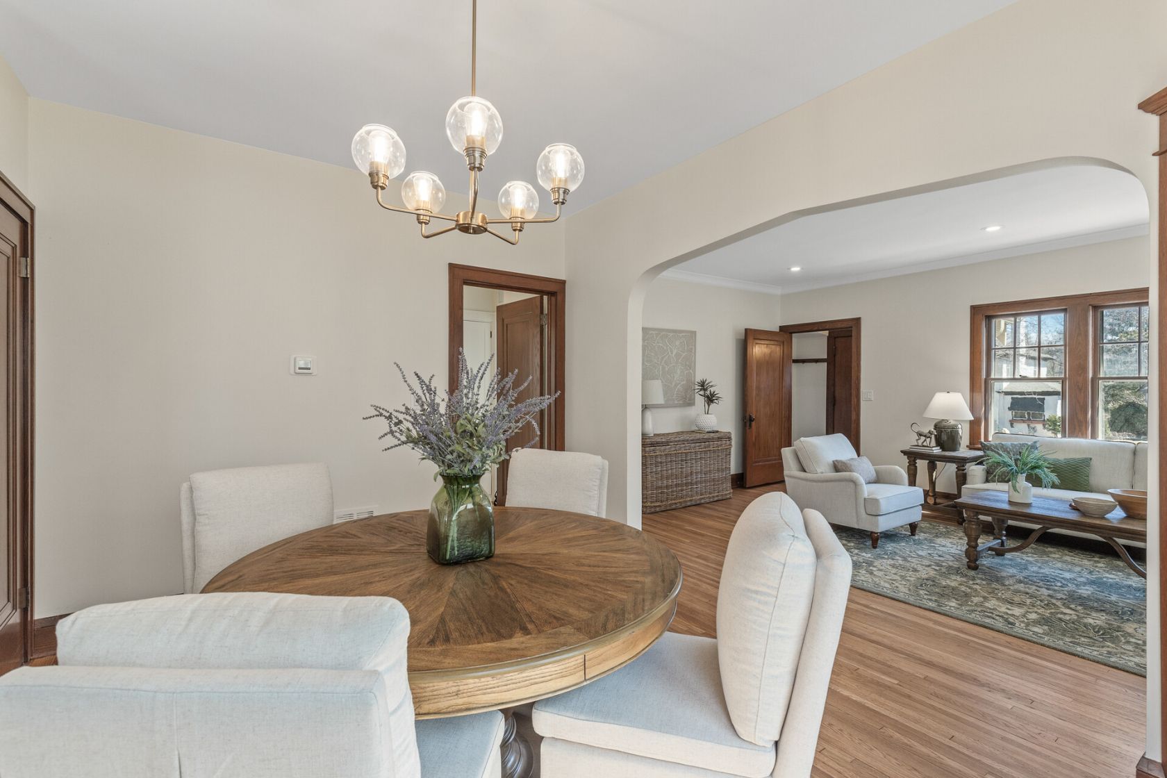 Dining room open to living room with refinished oak floors